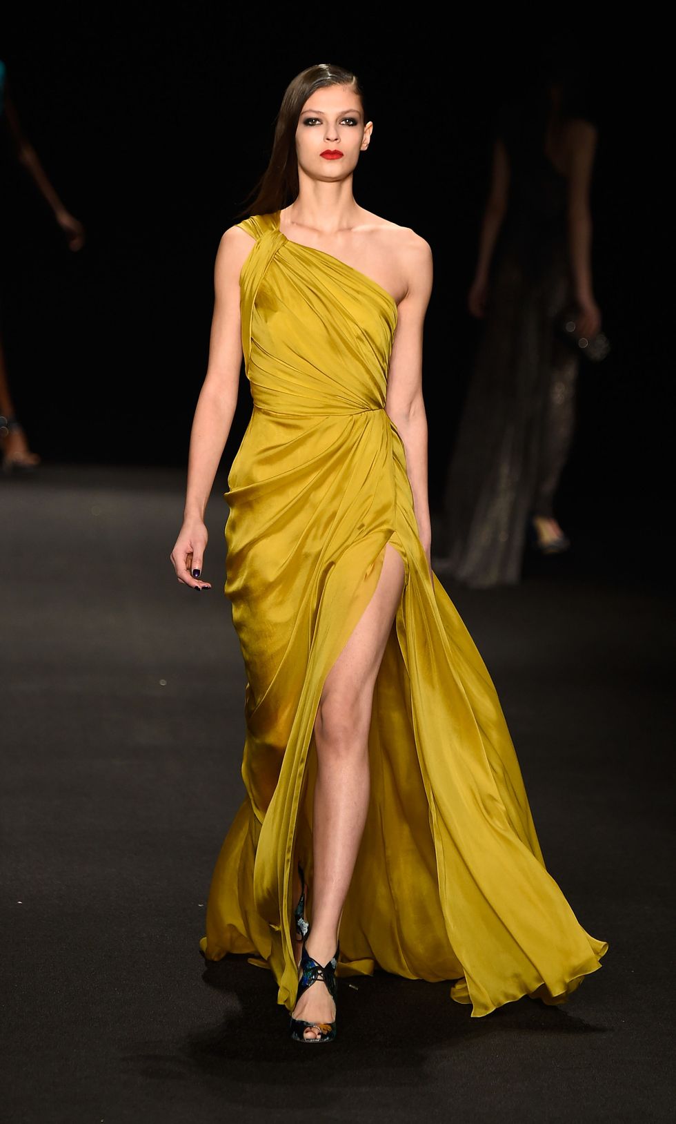 Yellow, Hairstyle, Shoulder, Dress, Joint, Fashion show, Fashion model, Formal wear, Style, One-piece garment, 