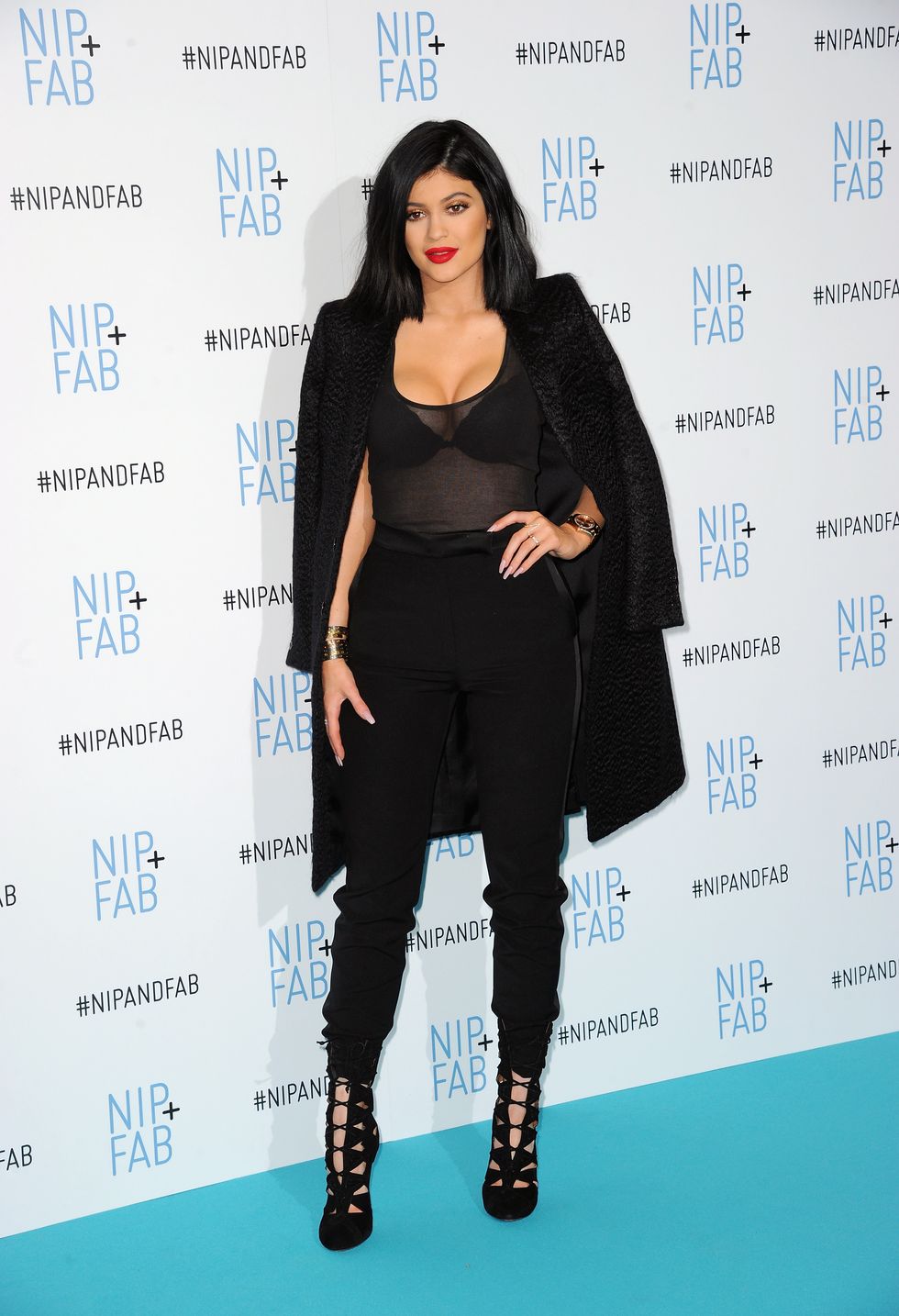 Kylie Jenner in black plunging outfit at Nip+Fab photocall