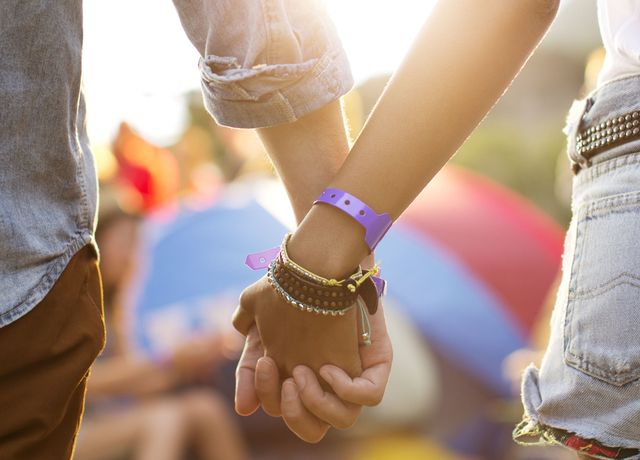 Couple holding hands at a festival