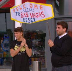 Joey essex holding a Bas Vegas sign