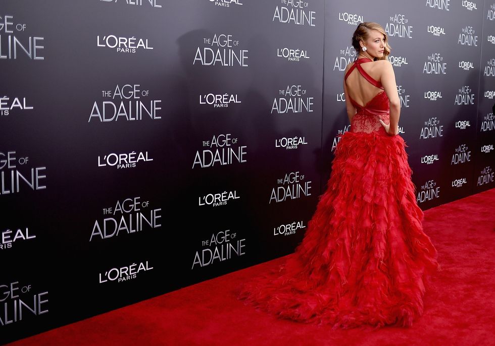Blake Lively wearing red feather dress at the premiere to new movie Age of Adaline