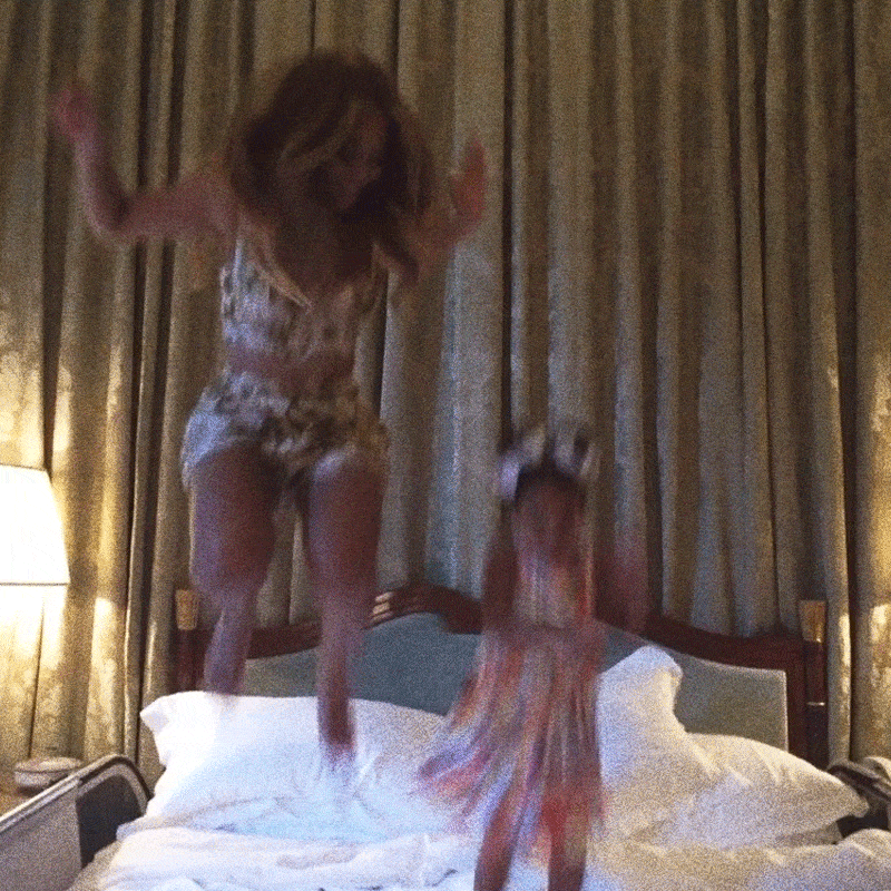 Beyonce and Blue Ivy jumping on a bed in Italy