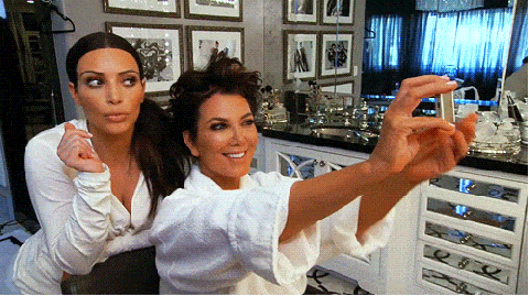 Kim Kardashian and Kris Jenner taking selfies while getting ready gif