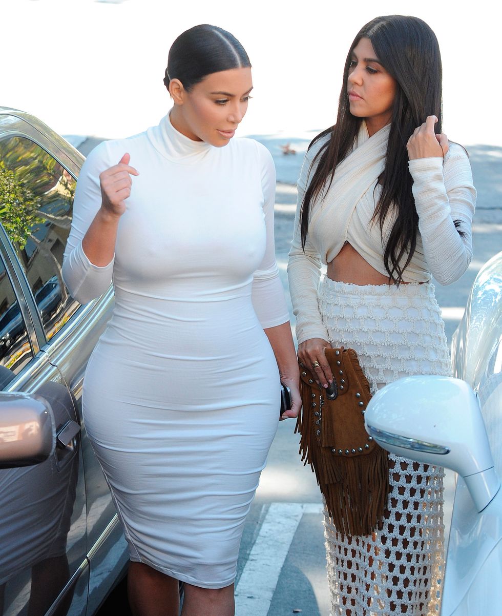 Kim Kardashian and Kourtney Kardashian wearing all-white