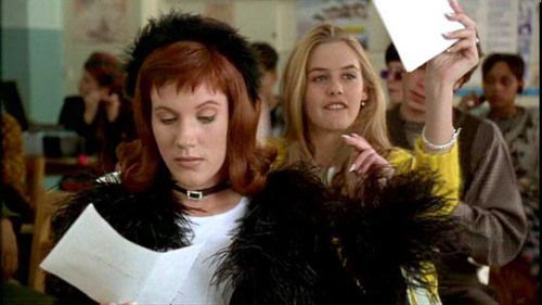 Amber from Clueless wearing black feathers and a hairband