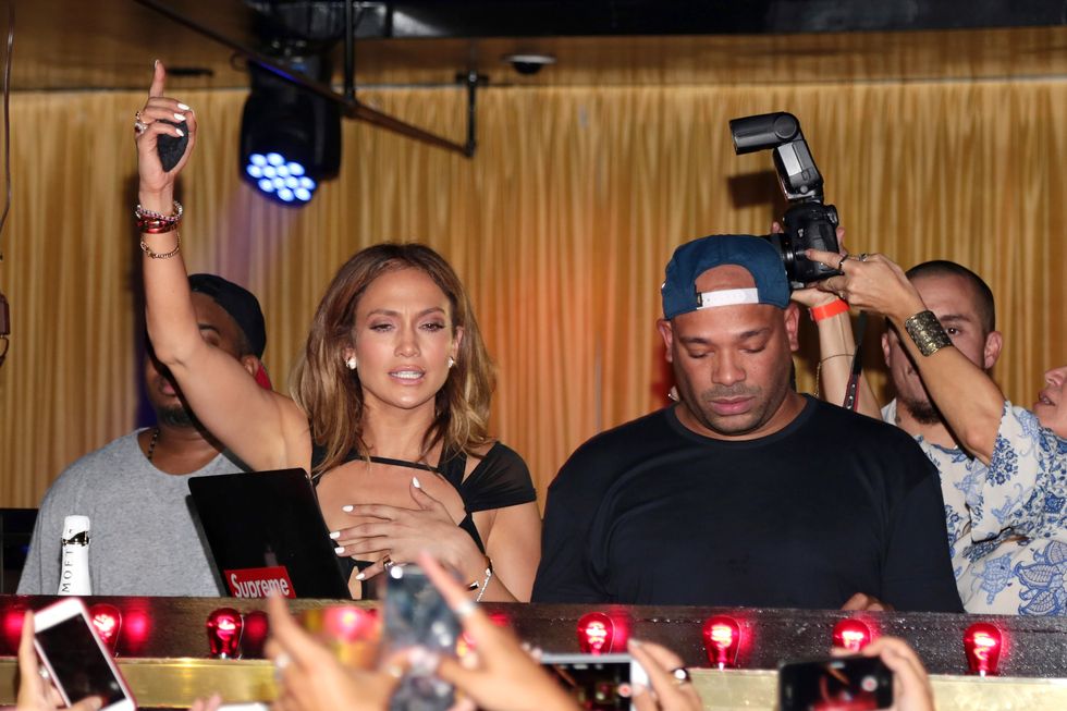 Jennifer Lopez points at the ceiling at her birthday celebrations at 1OAK