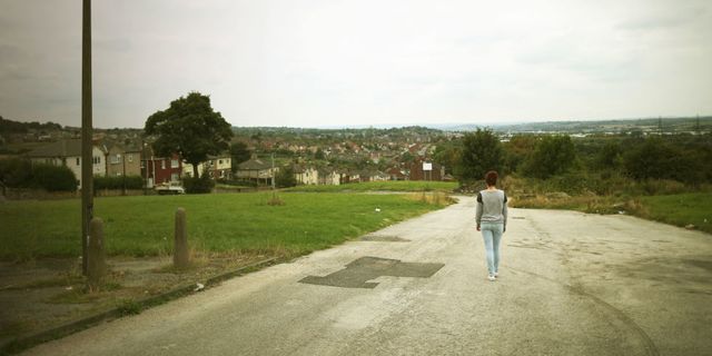 Woman walking alone down the street
