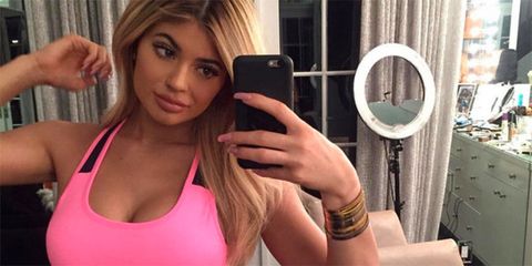 Kylie Jenner taking a selfie wearing sports bra