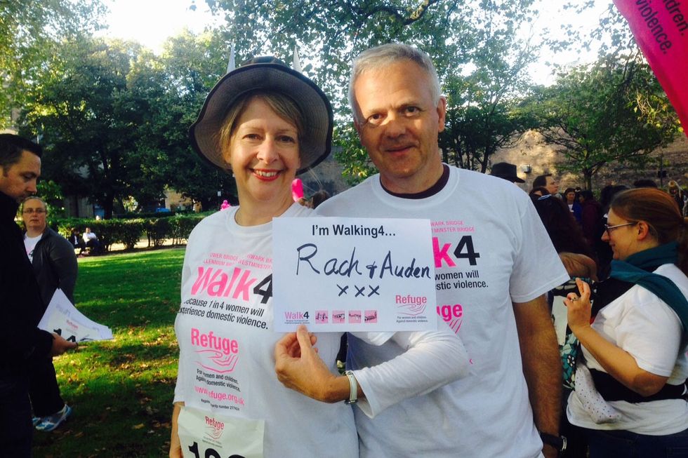 A couple holding a 'walking for' sign