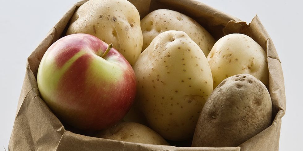 Apple in bag of potatoes