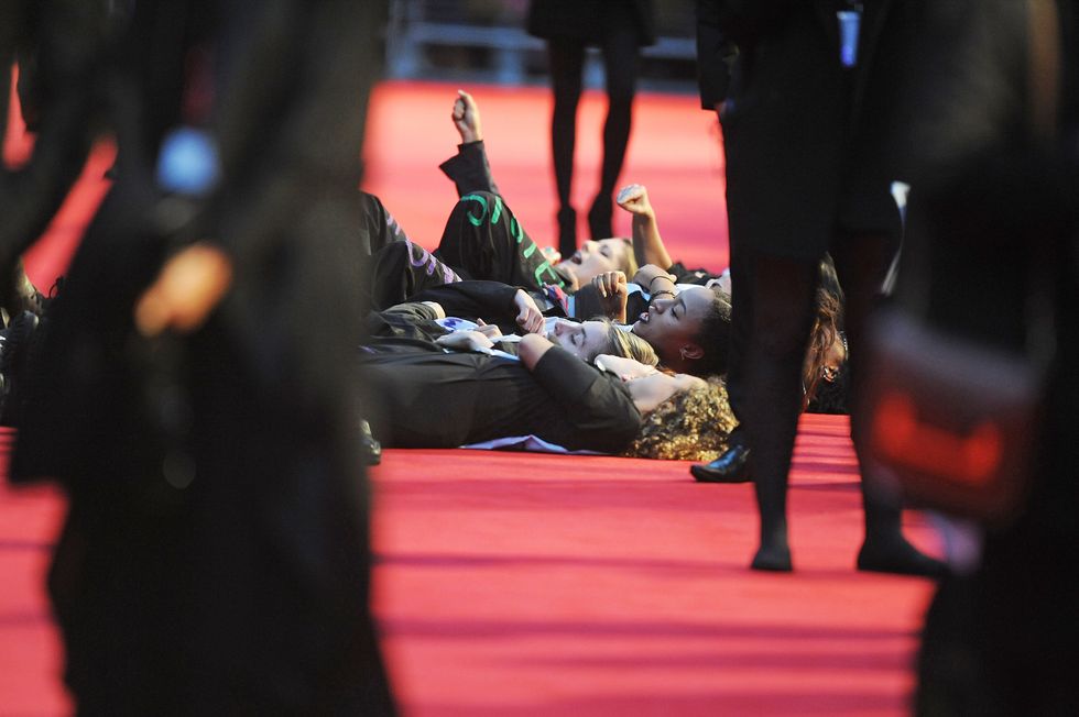 Domestic Violence campaigners lay down on the red carpet at the Suffragette premiere