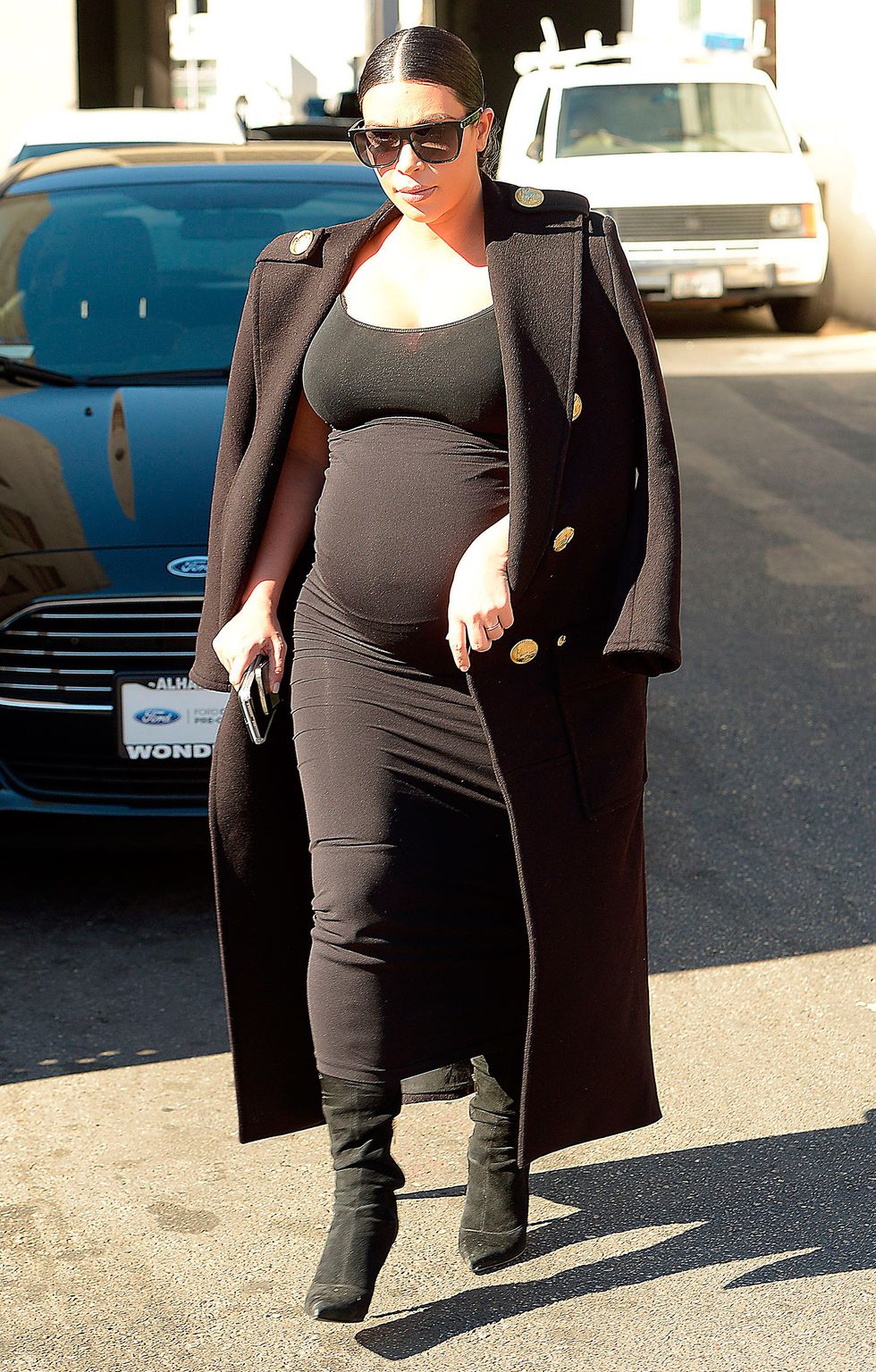 Kim Kardashian wearing all black dress and boots