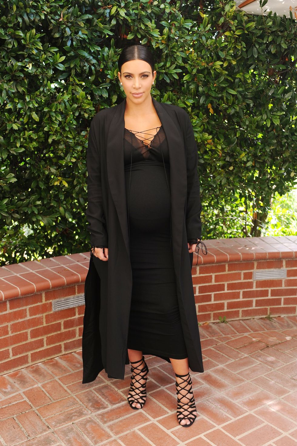 Kim Kardashian wearing black lace up dress