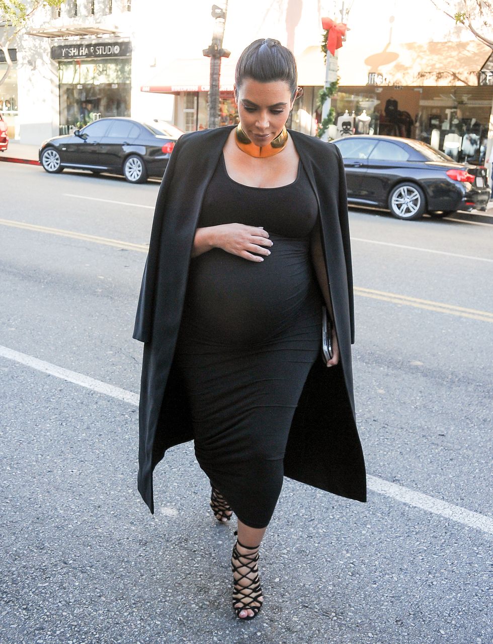 Kim Kardashian out wearing a black dress and coat