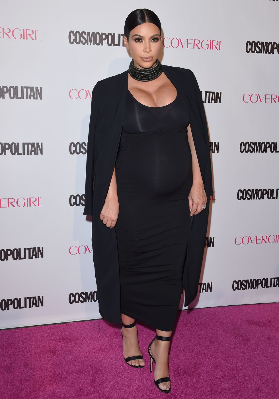 Kim Kardashian wearing a black dress and choker