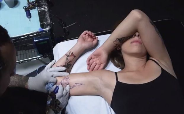 Watch this woman get 100 years of tattoo trends all over her body