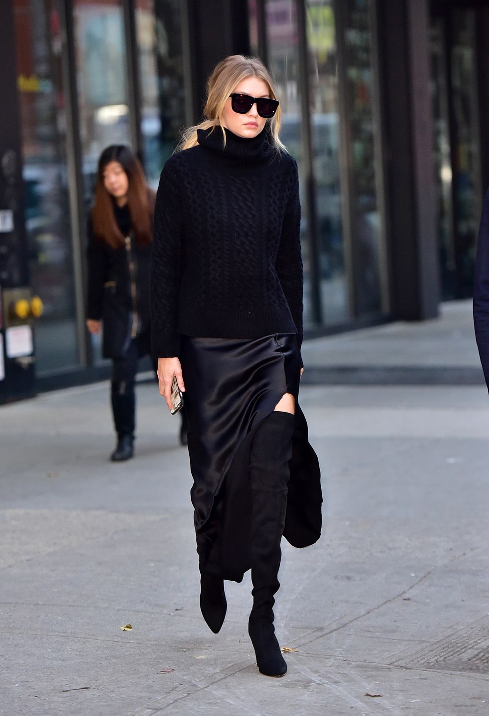 Gigi Hadid out and about wearing black boots and a jumper