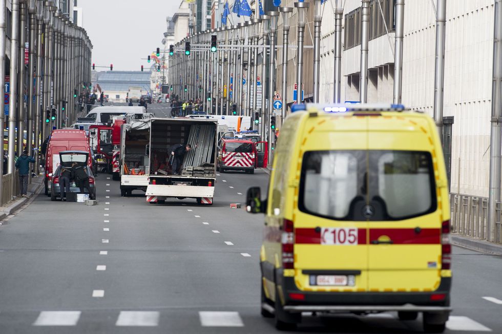 A picture taken on March 22, 2016 shows Belgian police and emergency staff arriving in the Wetstraat - Rue de la Loi, which has been evacuated after an explosion at the Maelbeek-Maalbeek metro station in Brussels.