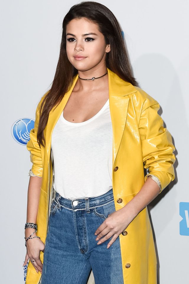 Selena Gomez wearing a yellow coat