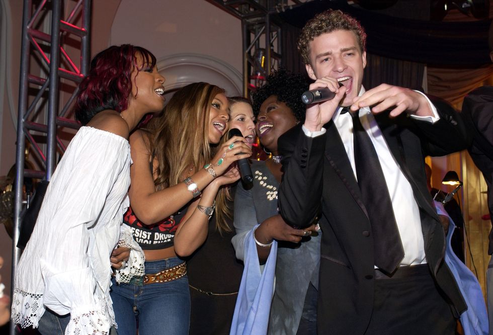 <p>Justin sings with Beyoncé <em>and </em><span class="redactor-invisible-space">Kelly Rowland during the pre-Grammys party in 2002.</span></p>