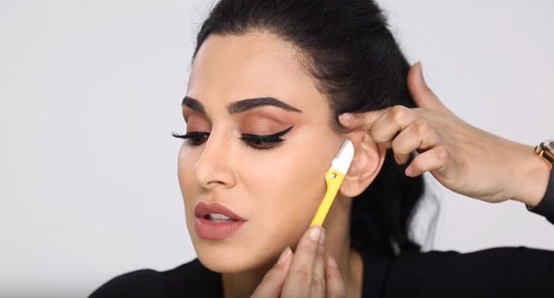 Huda Beauty demoes her face shaving technique