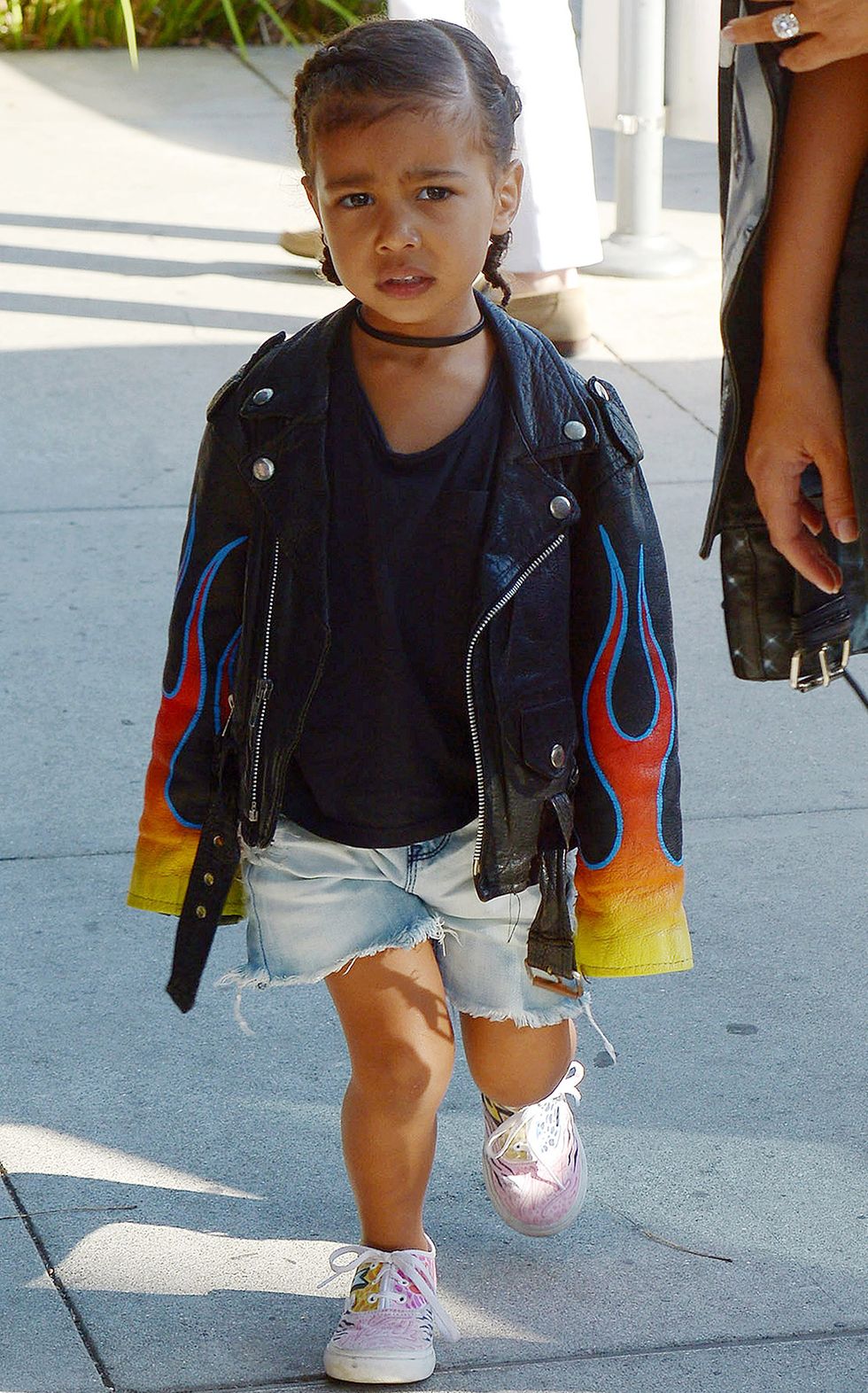 North West wearing a choker and leather jacket