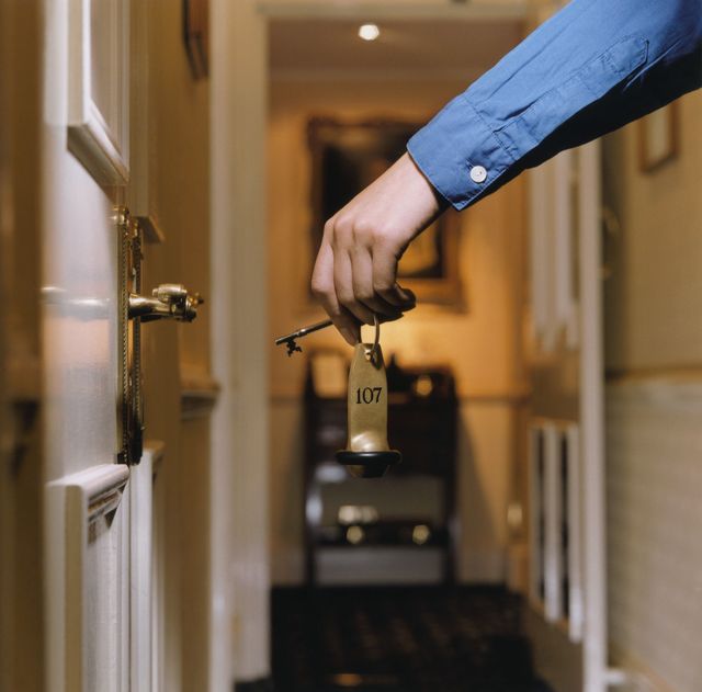Man entering hotel room with key