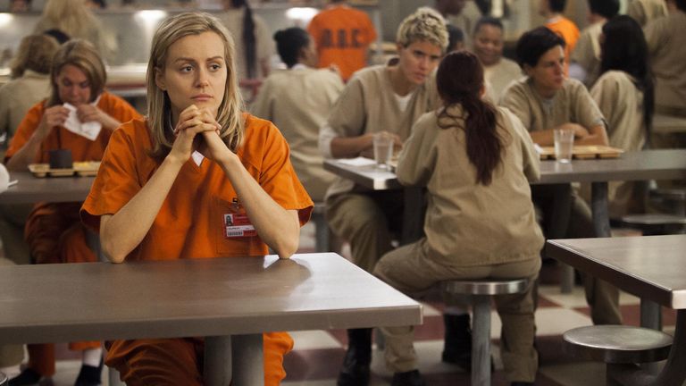 Piper sitting in the cafeteria in Orange is the New Black