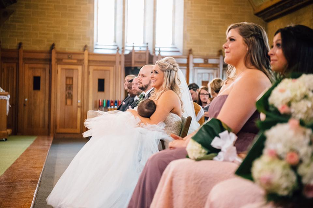 A photo of a woman breastfeeding her baby during her wedding has gone viral