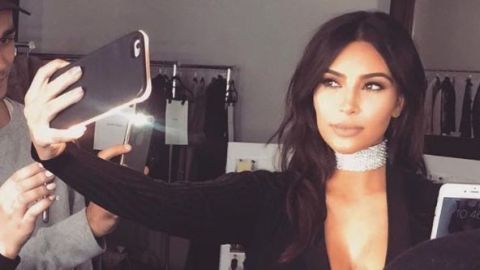 Kim Kardashian taking a selfie with her light up phone case