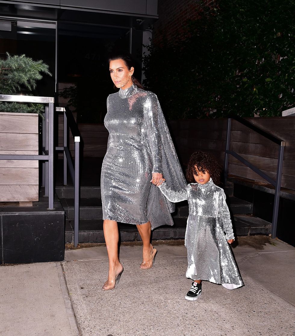 Kim Kardashian and North West wearing matching silver dresses