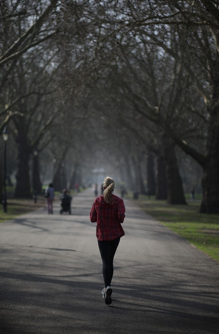 A jogger enjoys the spring sunshine in Battersea Park on March 15, 2012