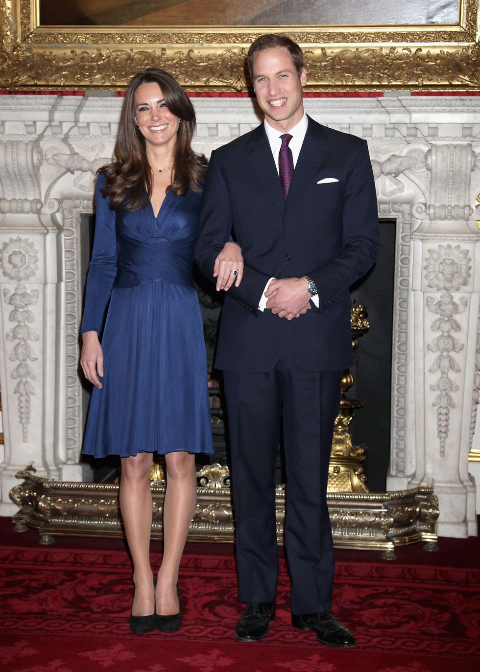 Kate Middleton engaged wearing a blue Issa dress