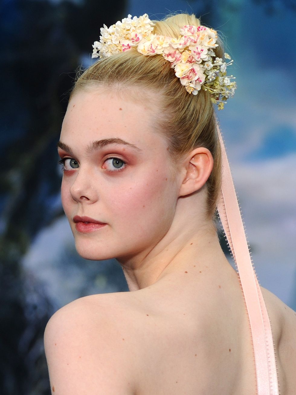 <p>It's only fitting Elle Fanning wore this look to promote Maleficent; the floral crown looping around her bun is a true fairytale look. And while we don't expect you to adorn yourself in ribbons like a Maypole, adding flowers to a tight topknot makes a great festival 'do.</p>
<p><a href="http://www.cosmopolitan.co.uk/beauty-hair/beauty-tips/wedding-hair-inspiration-how-to-choose-hair-accessory?click=main_sr" target="_blank">HOW TO CHOOSE A WEDDING HAIR ACCESSORY</a></p>
<p><a href="http://www.cosmopolitan.co.uk/beauty-hair/news/styles/hair-trends-spring-summer-2014?click=main_sr" target="_blank">THE HUGE HAIR TRENDS FOR 2014</a></p>
<p><a href="http://www.cosmopolitan.co.uk/beauty-hair/news/beauty-news/how-to-do-festival-plait-hairstyle?click=main_sr" target="_blank">HAIR HOW-TO: FESTIVAL PLAITS</a></p>