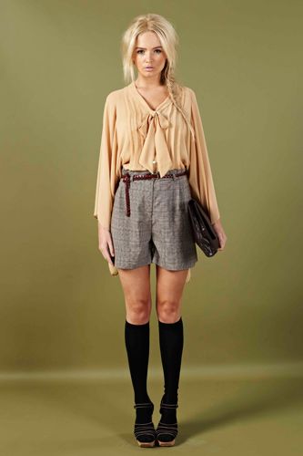 <p>Look sweet and innocent in this peach sheer blouse and high-wasted plaid shorts. Add a satchel and your school girl cool!</p>
<p>Harvey Blouse £20, Jeorgie shorts £18, <a href="http://www.boohoo.com/collections/70s-country-girl/icat/70scountrygirl/"target="_blank">boohoo.com</a></p>