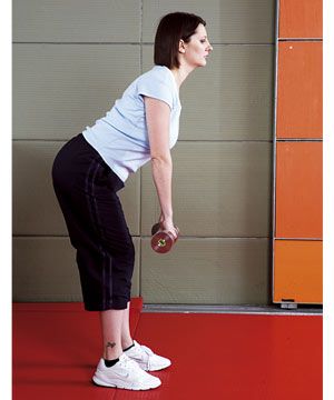 Holding a pair of weights, start with your legs straight but not locked at the knees. Bend forward from the hips, with your chest up and keeping your back straight. Lower towards the floor for a count of three before returning to the start position.<br />
