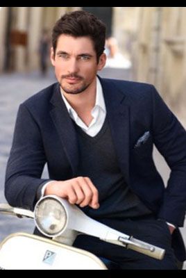Outerwear, Coat, Formal wear, Scooter, Sitting, Suit, Blazer, Street fashion, Facial hair, White-collar worker, 