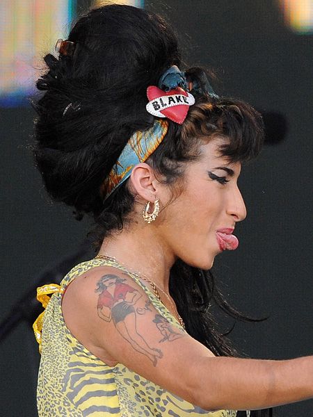 <p>Amy wore her heart on her headscarf to keep her trademark beehive in place</p>