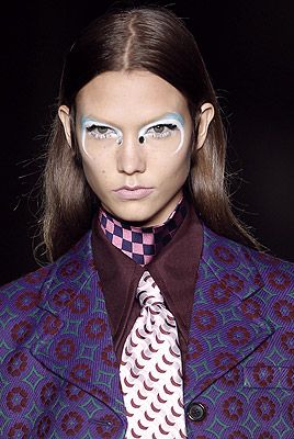 <p>Strong and striking layered eyeshadows were seen at Prada where greasepaint (yes) was applied in layers of orange and black at the top (and right up into the brows) to complement black and purple kohl below the lower lash line. To intensify the effect, matte white pencil was applied to the inner rim, which also made the eye colour pop.<br /> </p>
