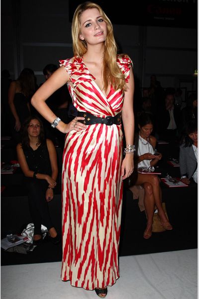 <p>Mischa put in an appearance at Fashion For Relief in a floor length red and cream wrap dress given shape by a waist cinching belt. Does she look chic at fashion week? </p>