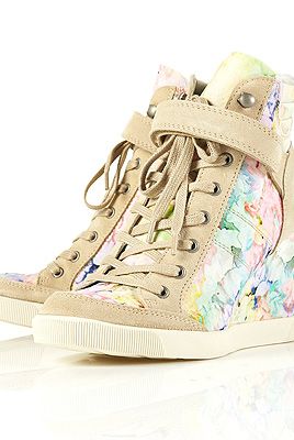 <p>Think the sports luxe trend is for tomboys only? Think again. These pretty floral hi-tops from Toppers have a concealed wedge so you won't have to forfeit your heels, either. Game ON!<br /><br />Floral wedge trainers, £75, <a title="http://www.topshop.com/webapp/wcs/stores/servlet/ProductDisplay?beginIndex=0&viewAllFlag=&catalogId=33057&storeId=12556&productId=5469797&langId=-1&sort_field=Relevance&categoryId=277012&parent_categoryId=208491&pageSize=200" href="http://www.topshop.com/webapp/wcs/stores/servlet/ProductDisplay?beginIndex=0&viewAllFlag=&catalogId=33057&storeId=12556&productId=5469797&langId=-1&sort_field=Relevance&categoryId=277012&parent_categoryId=208491&pageSize=200" target="_blank">Topshop</a></p>