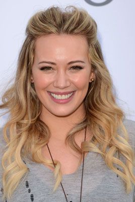 <p>Curls don't have to be wham, bam, gorgeous and glam, we like them nice and natural too and you can't go wrong with Hilary Duff's flowing curls. Quiffing your hair at the front and smoothing it back means there's no need to deal with roots and is great for disguising grease too while the rest of her hair has been loosely tongued to create a summer finish that you could easily eek out for two days.</p>
<p><strong>Top Tip:</strong> If you're curling your hair with a tong, only rough dry your hair otherwise it will be too smooth and won't hold as well</p>