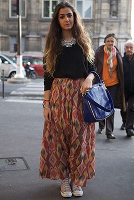 <p><em>Jewellery designer</em></p>
<p>We love seeing designers wearing their own work at the shows. Jewellery designer Nisrine Harakat matched her bracelets with a classic Givenchy bag then dressed the outfit down with Converse and tucked an H&M jumper into a skirt she also made herself.</p>