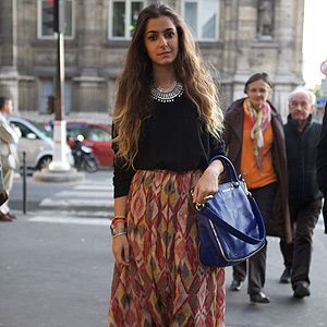 <p><em>Jewellery designer</em></p>
<p>We love seeing designers wearing their own work at the shows. Jewellery designer Nisrine Harakat matched her bracelets with a classic Givenchy bag then dressed the outfit down with Converse and tucked an H&M jumper into a skirt she also made herself.</p>