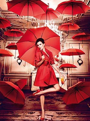 <p>Penelope Cruz told us this scene was her favourite in the series. She wore a beautiful red Alaia trench coat paired with Casadei shoes while flaunting a glass of Campari Orange. Why open an umbrelle indoors when you've got a roof above your head? If it matches the outfit, why not!</p>
