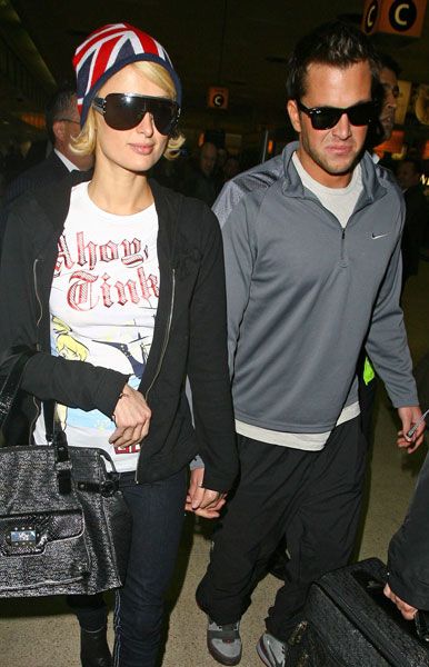 Paris Hilton was showing her love for the UK with her Union Jack hat as she headed to Heathrow with boyfriend <a target="_blank" href="men/man-watch/gallery">Doug Reinhardt</a>. The heiress spent her brief break over here parting at almost every single exclusive club in London...  <br />