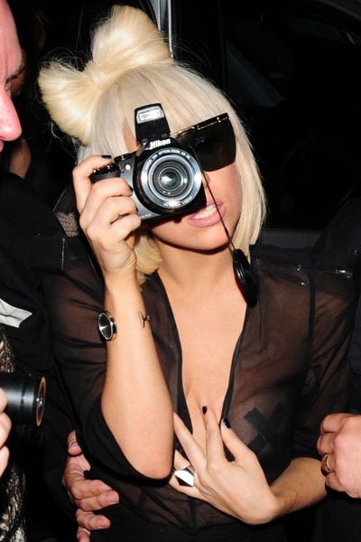 Lady GaGa covered her modesty (in this case, her nipple) with a bandage as she left Bungalow 8 in London. The pop star was busy snapping paparazzi in preparation for her next single, 'Paparazzi'!  <br />