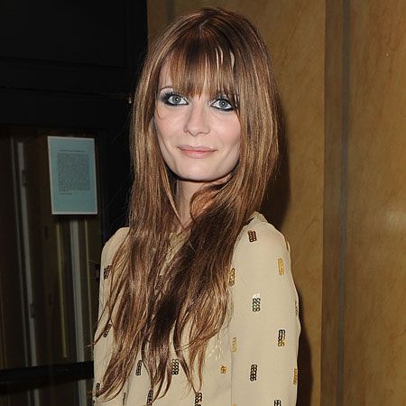 An unusually smiley Mischa Barton happily posed for photographers in a floor length gold gown at the FiFi Fragrance Awards held at the Dorchester hotel...  <br />