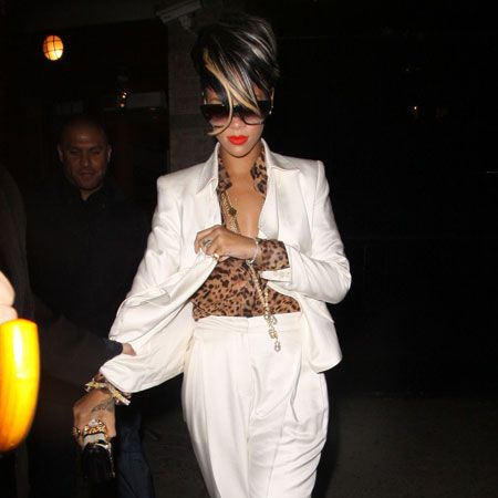 Rihanna has been a busy bee since lying low and taking a well deserved break in her native Barbados. The singer is back on the scene and showcasing new blonde highlights and lots of glamorous outfits. Here she is in a white blazer and leopard-print shirt tucked into white high-waisted trousers as she left posh New York eatery De Silano. And standing under her minder's umbrella-ella-ella...  <br />