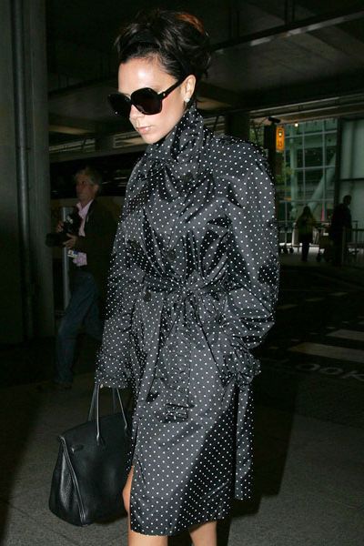 Posh was kept under wraps in her polka-dot mac, oversized shades, Hermes handbag and Louboutins as she arrived at Heathrow from JFK. Always one to arrive in style...  <br />